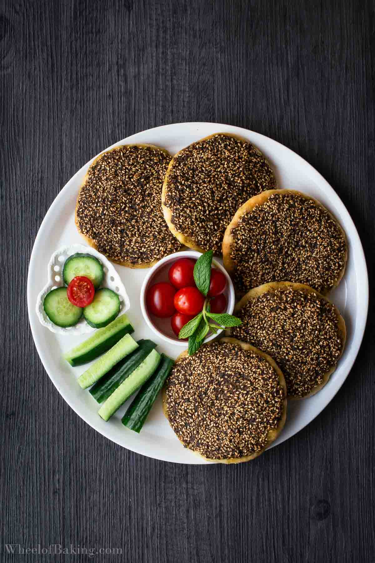 Middle Eastern Manakish Za'atar served with cucumbers, tomatoes and mint.