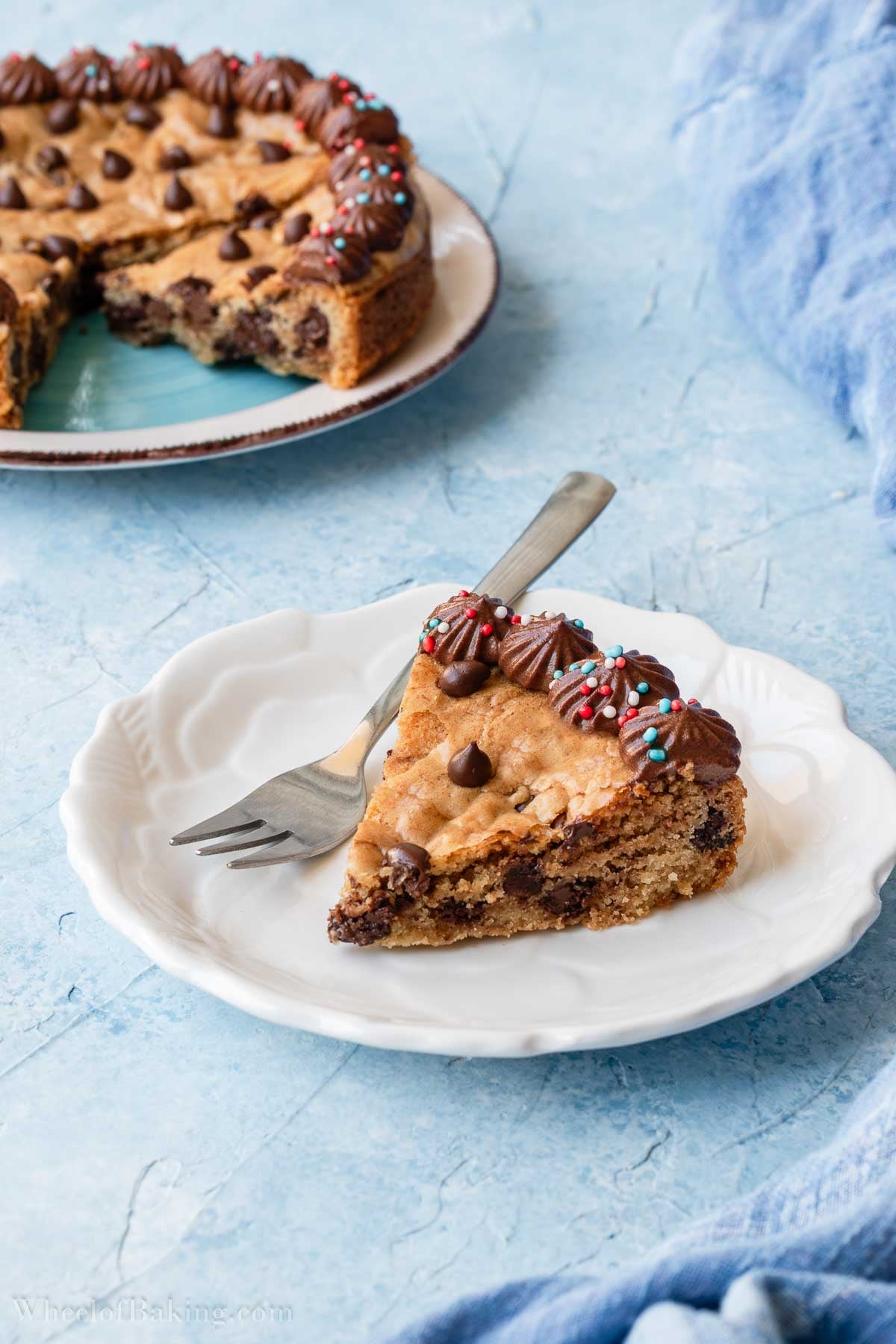 One slice of the mini chocolate chip cookie cake in a white plate.